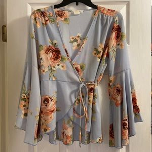 Size small blue wrap around blouse. Poly/Span. Baby blue V-cut neckline.